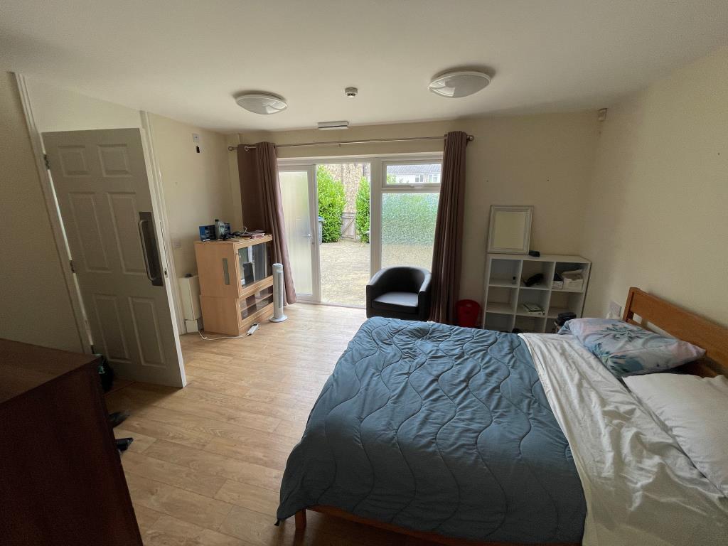 Lot: 98 - TWO FLATS AND ANNEX IN VILLAGE LOCATION - Bedroom with access to front patio
